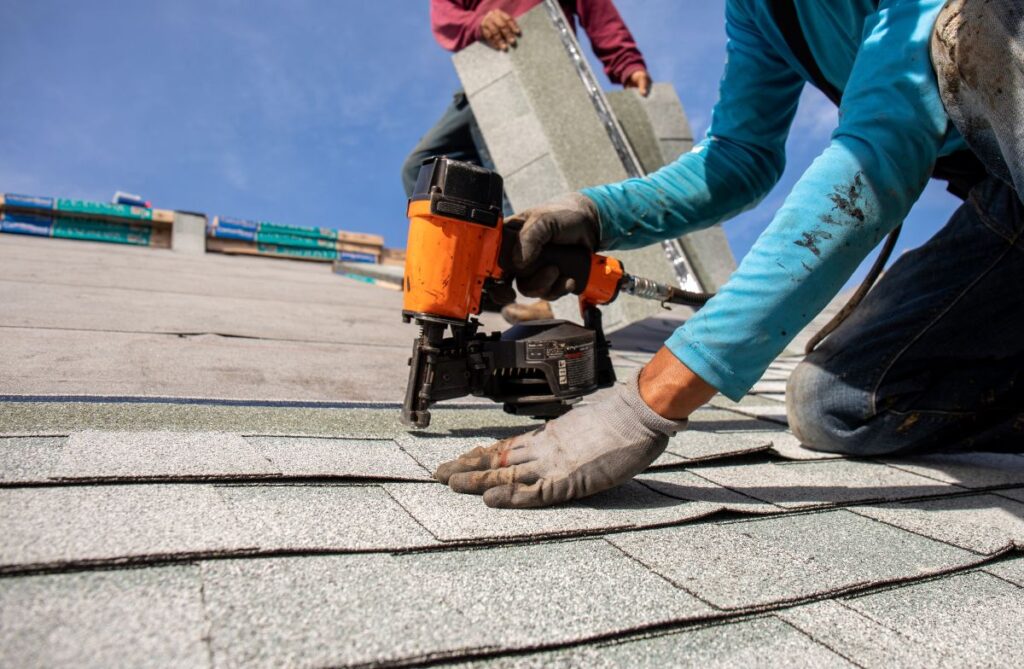 roofer installing roof shingles