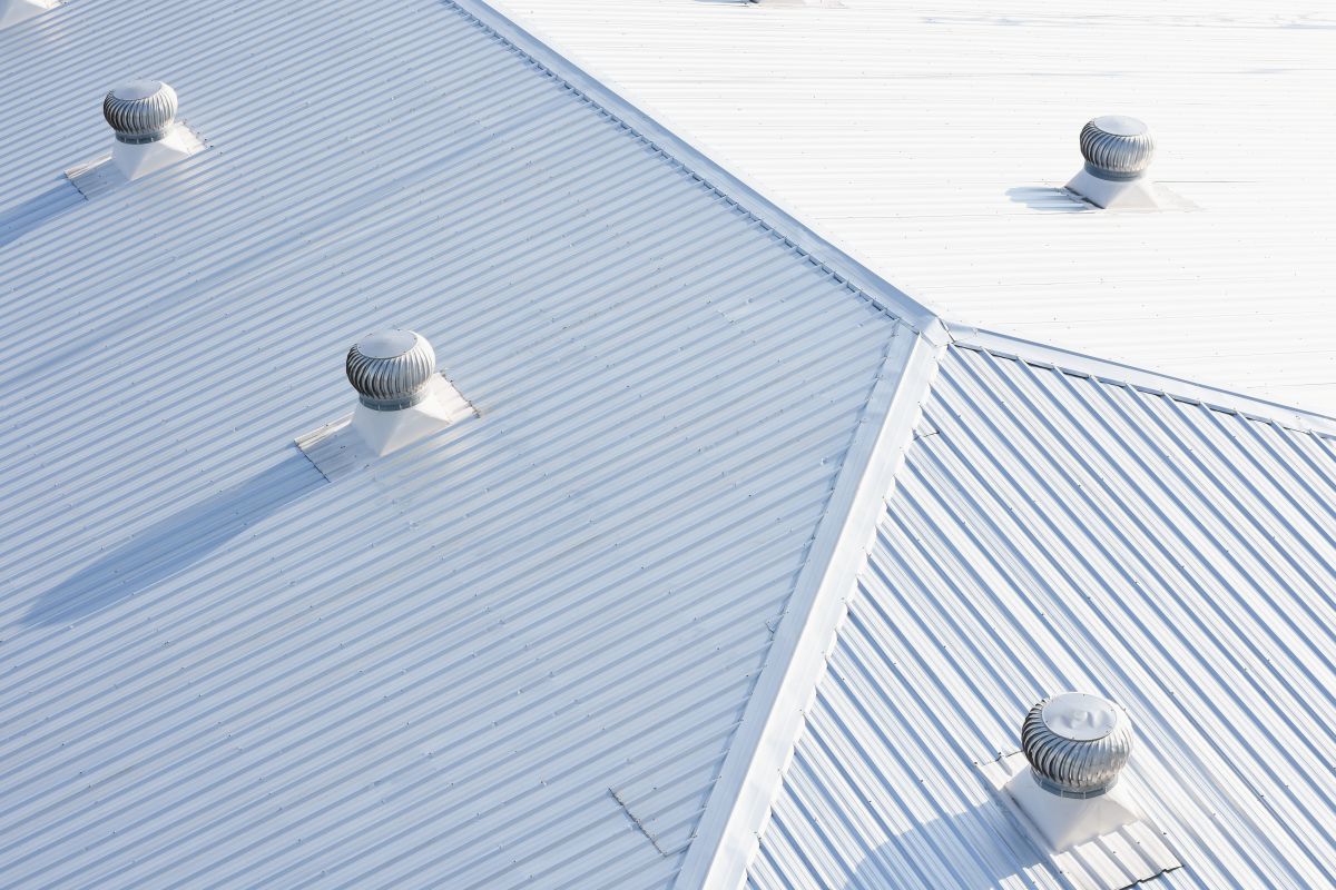 metal sheet roofing on commercial construction with blue sky, in White Bear Lake
